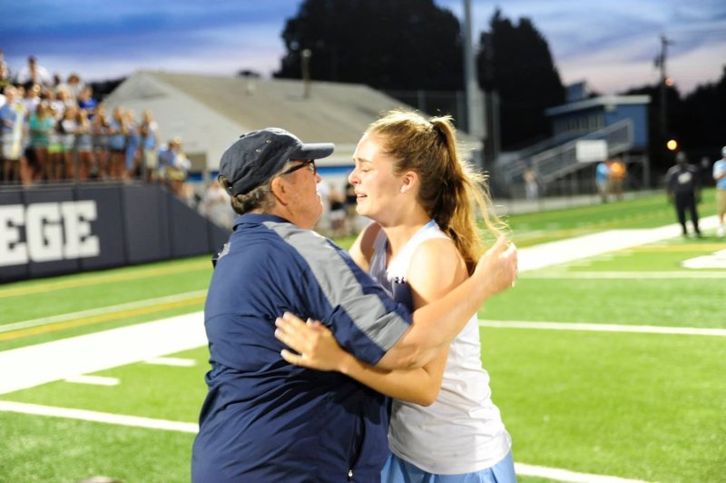 Coach Debbie Windett congratulates Lizzie Frederick after lacrosse state championship.